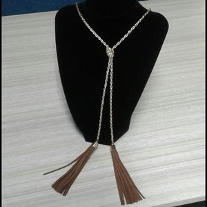 Gold  colored very long chain with suede tassels